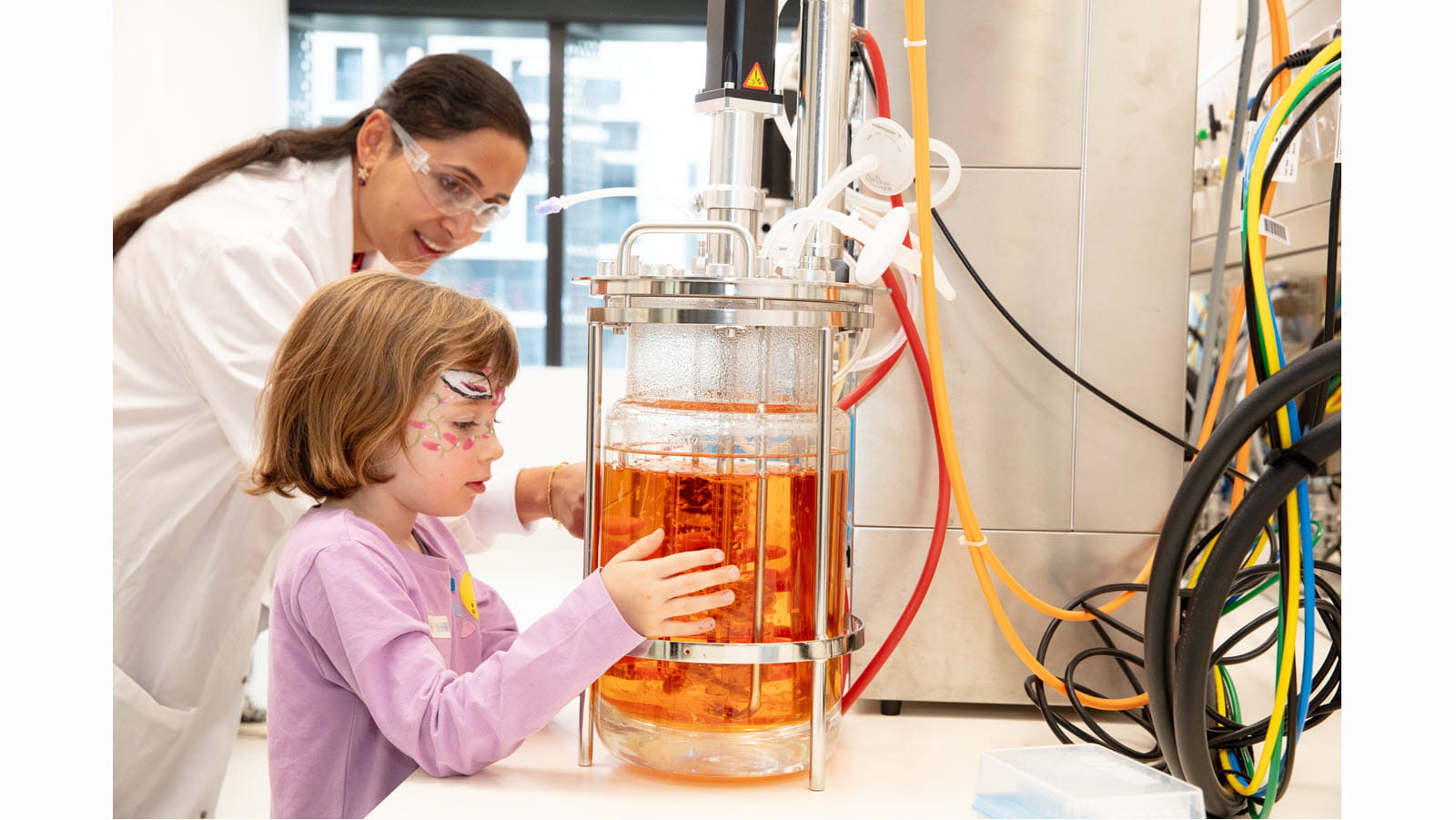 A child gets an up-close look at laboratory equipment during CSL's Friends & Family Day in Melbourne, Australia.