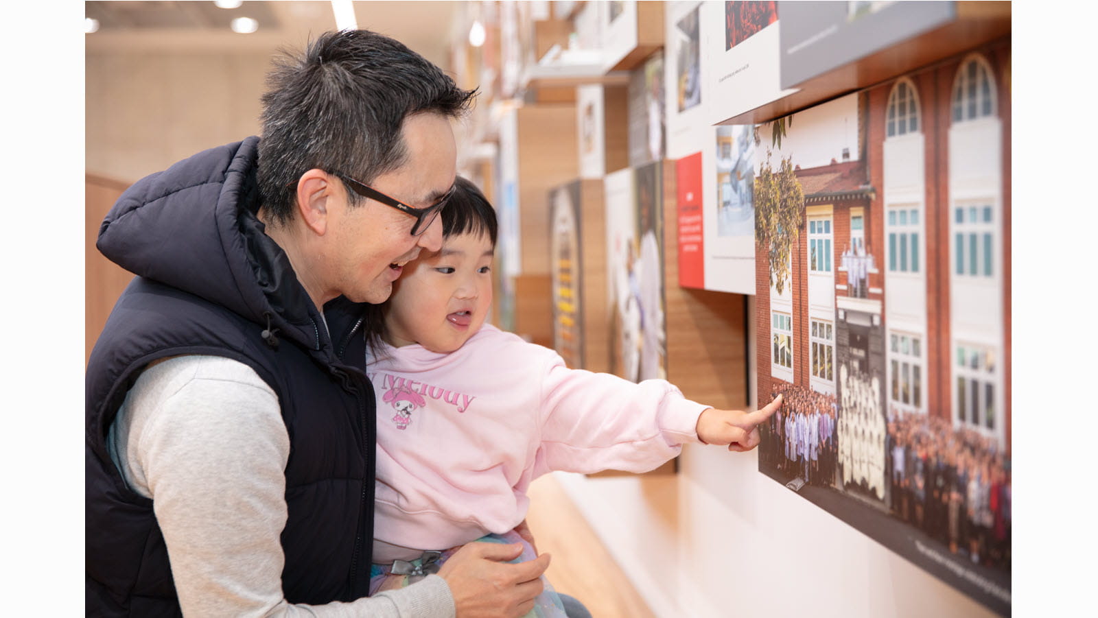 A child points to a wall display at CSL's Friends & Family Day.